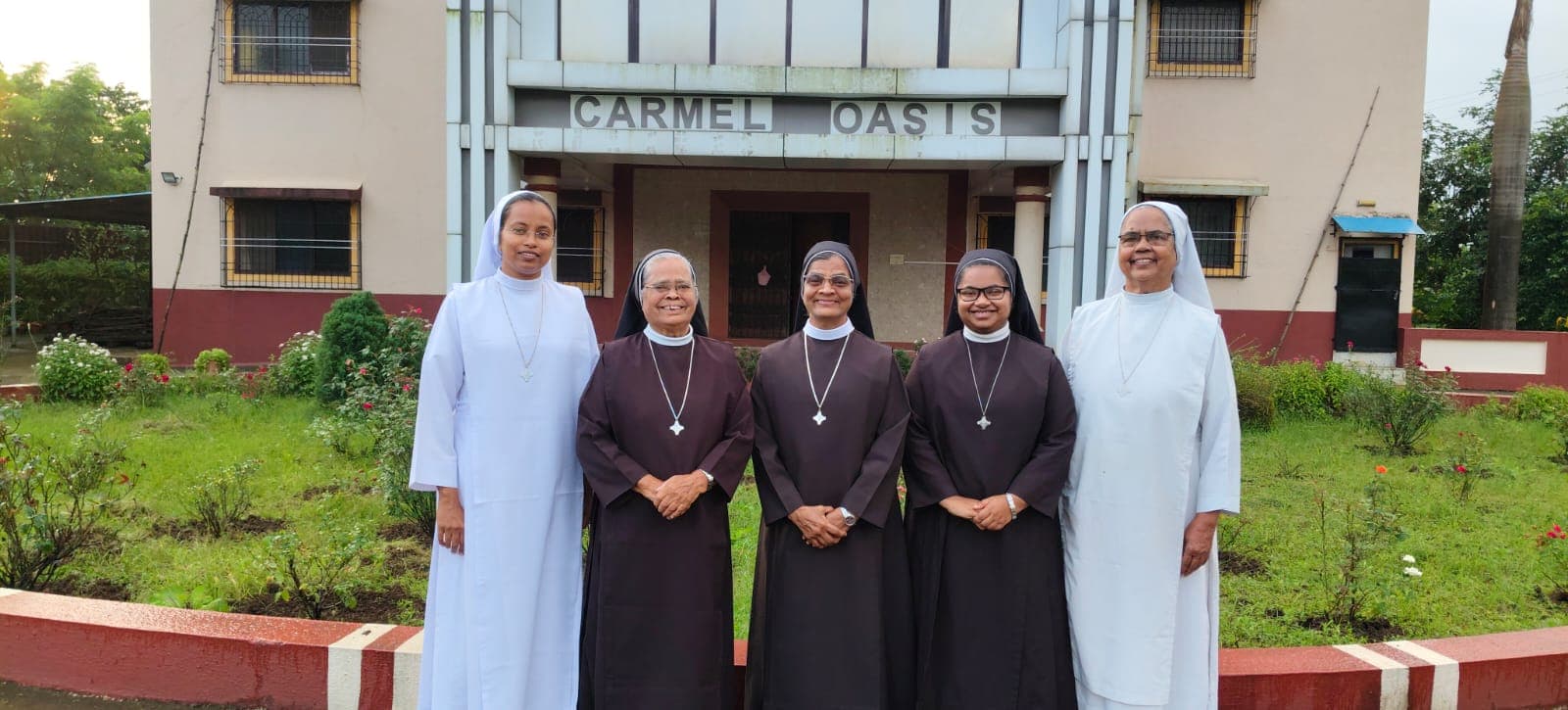 The sisters standing together in front of the Carmel Oasis entrance.